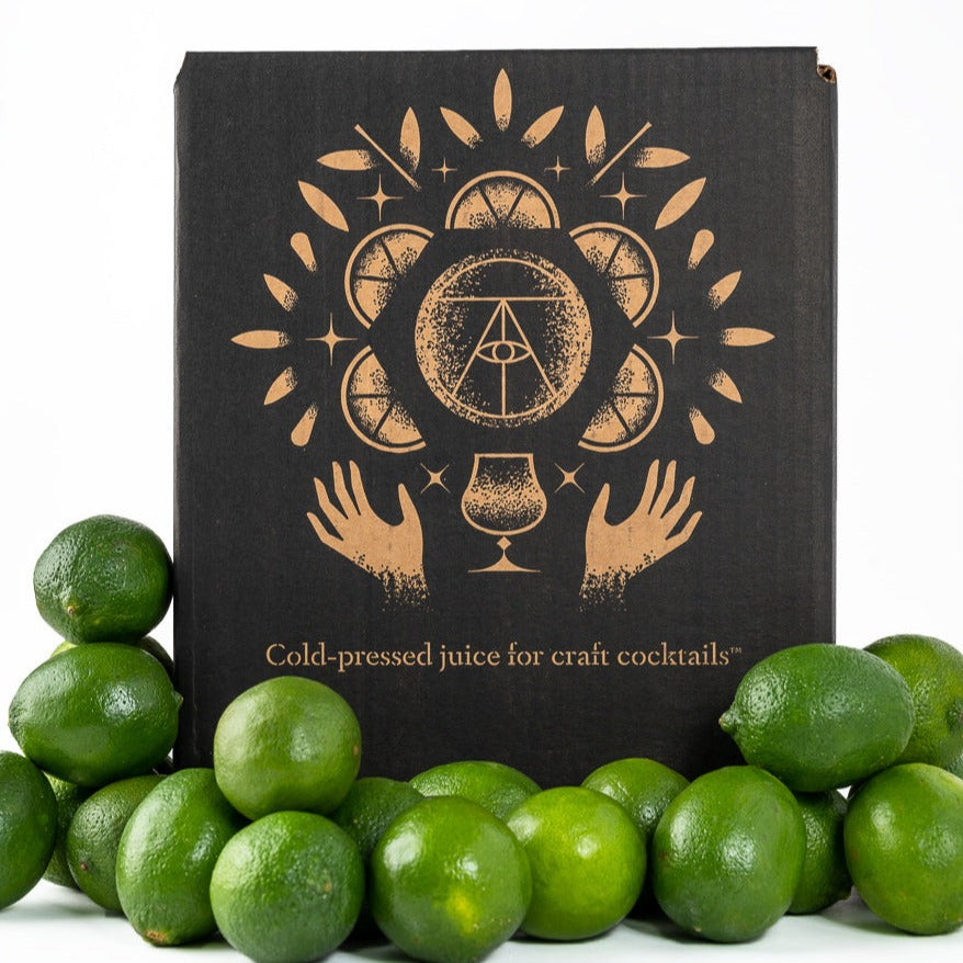Twisted Alchemy box with limes in the foreground