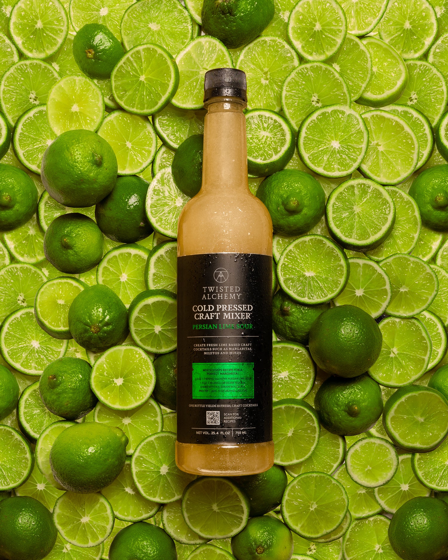 LIME BOTTLE ON BACKGROUND OF LIMES