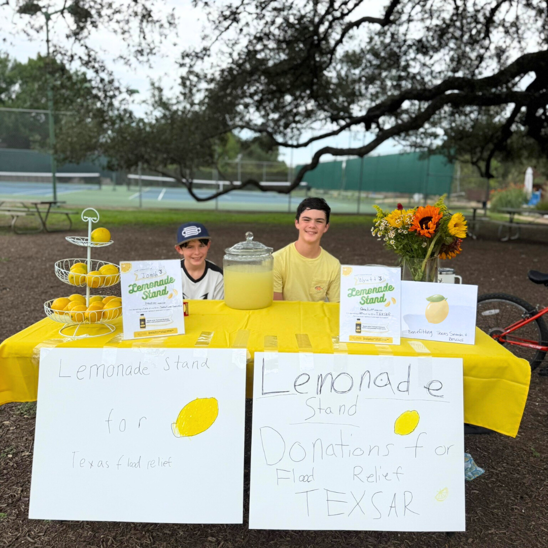 Kids setting up TA lemonade stand for Texas