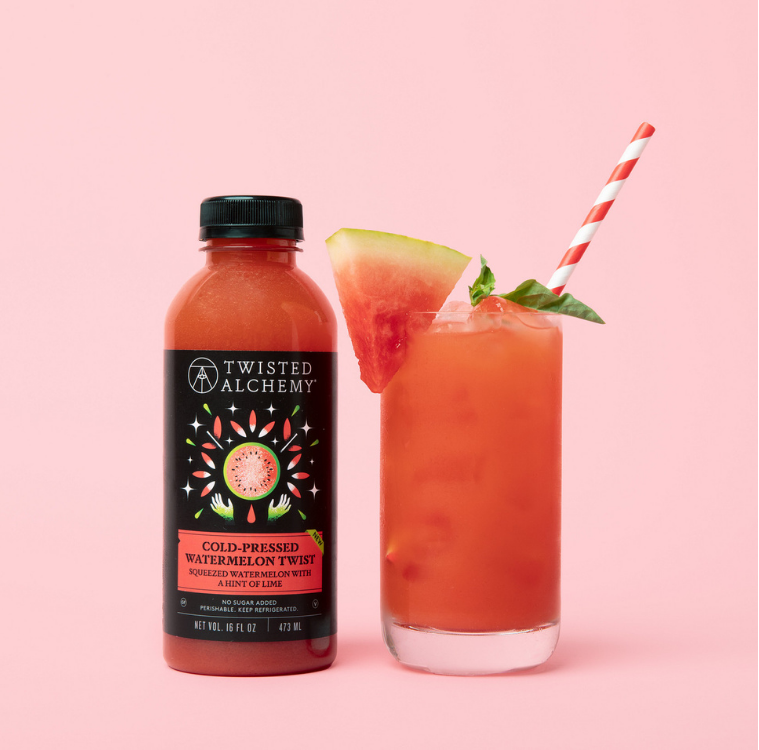 Twisted Alchemy watermelon juice bottle and glass with a drink on a pink background